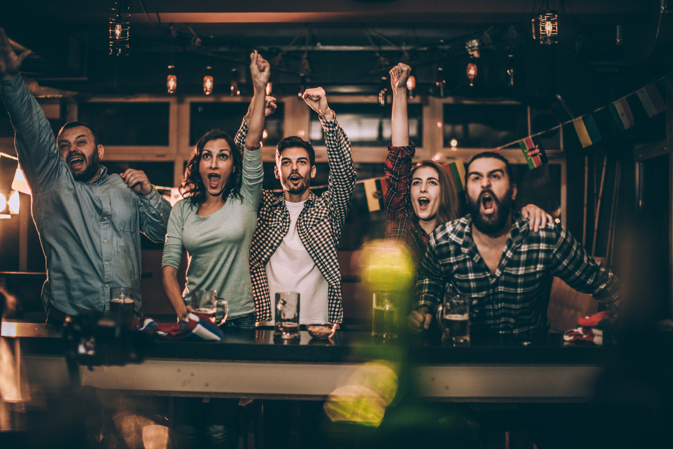 Friends in bar watching game